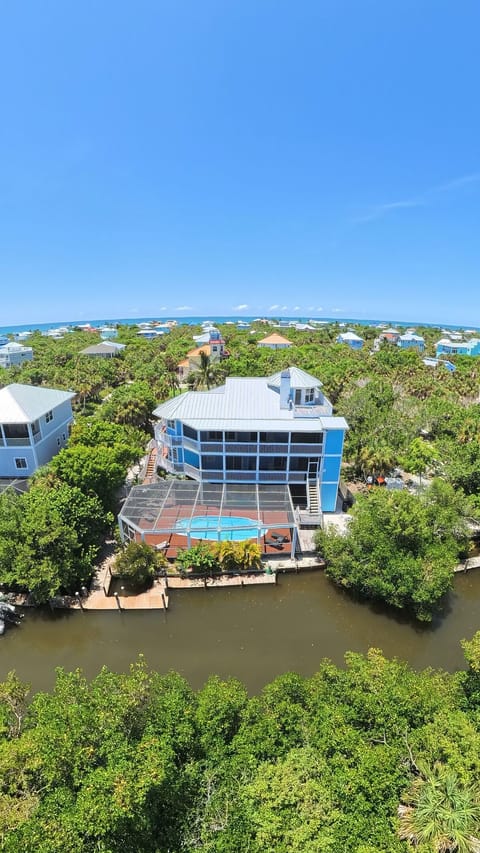 Twin Dolphins — a private canal-front North Captiva retreat featuring a screened pool, private dock and beautiful island views.