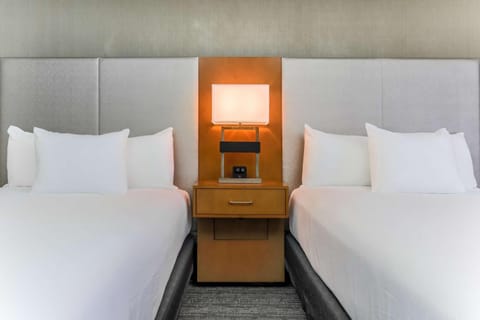 Drift off between plush pillows and warm bedside lighting.
