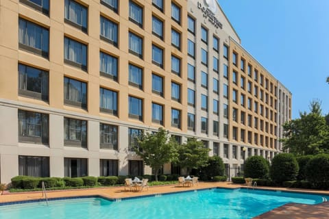 Arrive to a polished hotel exterior with resort-style pool.