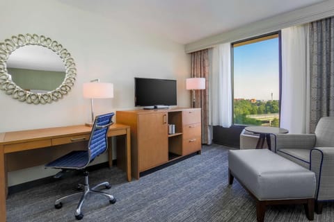 Unwind in a spacious king room with cozy seating.