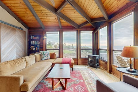 Bask in the warmth of the gas fireplace as you enjoy ocean views and cozy gatherings in this inviting living space.