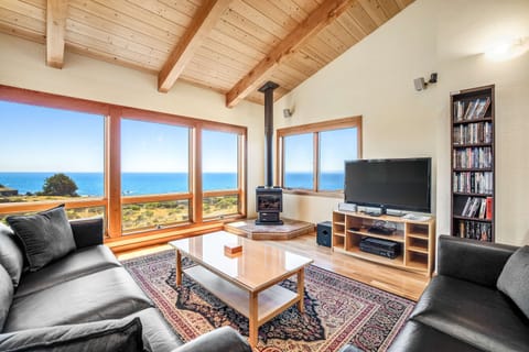 Gaze out at the ocean from your cozy living room, where the warmth of the gas fireplace invites relaxation after a day of adventure.