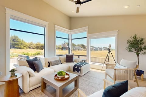 Morning light fills the living room, inviting you to sip coffee while gazing out at nature.