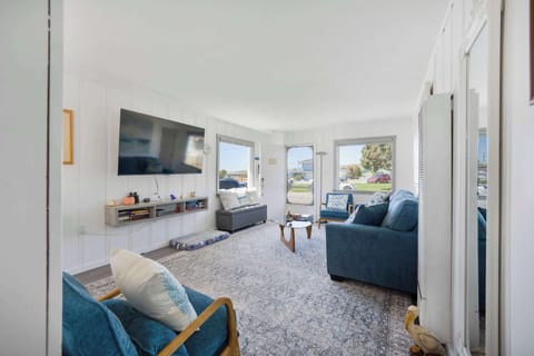Living room features a smart TV, queen sized pull out couch and ocean views!
