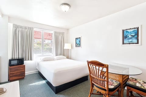 Unwind in a bright, simple room with cozy linens.
