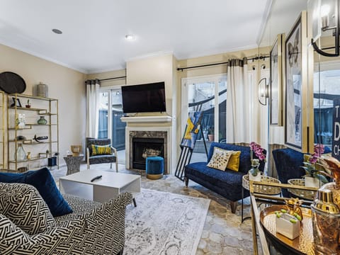 Unwind in your stylish living room featuring plush seating, a cozy fireplace, and modern entertainment setup for perfect relaxation.