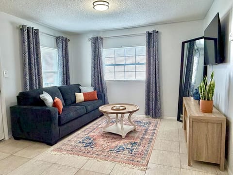 Stylish living room with smart TV and queen sleeper sofa for extra accommodations.