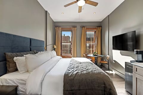 Recharge in a sunlit king bed with crisp linens.