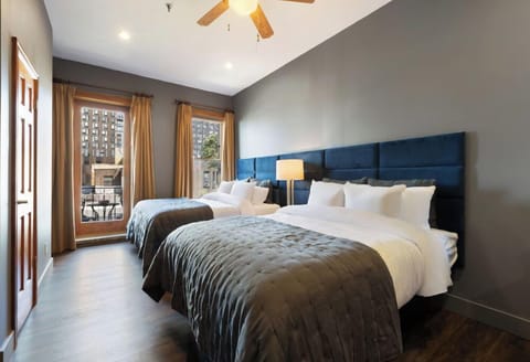 Settle in together with two plush beds and balcony access.