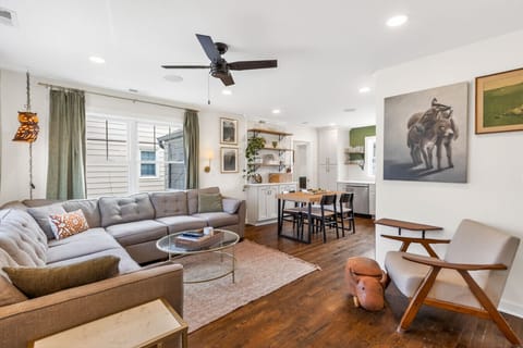 A warm, open-concept living space with cozy seating, natural light, and a seamless flow into the dining area—perfect for relaxing or entertaining.