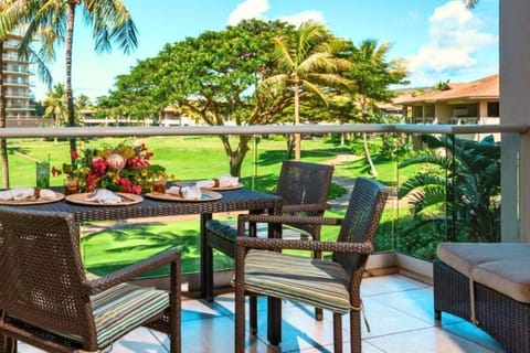 Private lanai with lush garden views and a dining table perfect for morning coffee or open-air meals. HKH-240