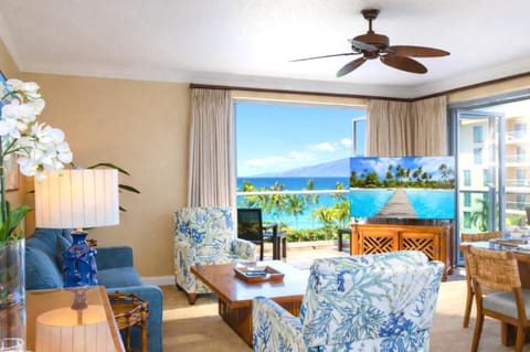 From your living room sofa, you enjoy a direct view of the lanai and ocean beyond, creating a breezy indoor outdoor space for lounging together. HKH-515