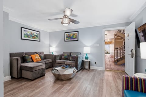 Airy open living space w/ ceiling fan & a smart, welcoming layout.
