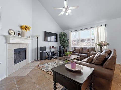 Relax in your spacious living room with plush leather seating, cozy fireplace, and entertainment center for perfect evenings in.