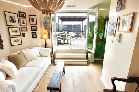 Bright living room with French doors leading to the private roof deck, your own indoor/outdoor retreat above the city.