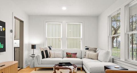 Gather on the oversized sectional with room for the whole crew. Natural light fills the space through large windows.