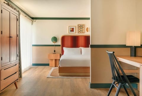 Unwind in a spacious bedroom with warm mid‑century style.