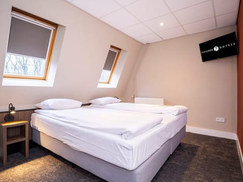 Recharge in a snug, quiet bedroom tucked under cozy skylights.