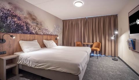Unwind in crisp linens beneath a soothing nature mural.