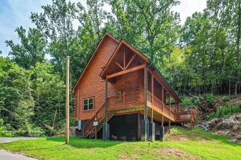 Stunning log cabin nestled among towering trees, featuring rustic wood siding and covered decks perfect for mountain getaways.