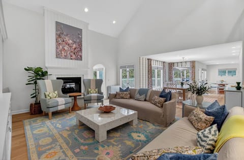 Unwind in your spacious living room with vaulted ceilings, cozy fireplace, and stylish furnishings that create the perfect atmosphere for relaxation.