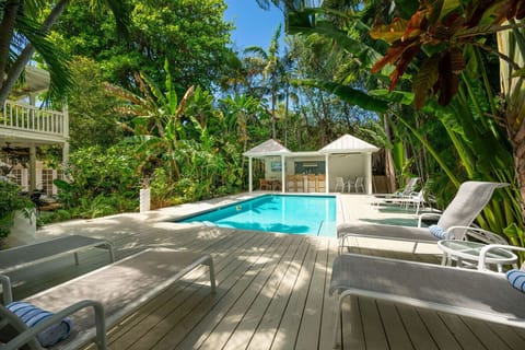 Private 24` x 18` pool with outdoor kitchen and tropical surroundings