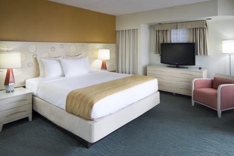 Sink into crisp linens in a calm, modern king room.