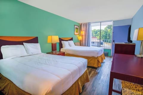 Unwind in bright double-queen comfort with balcony daylight views.