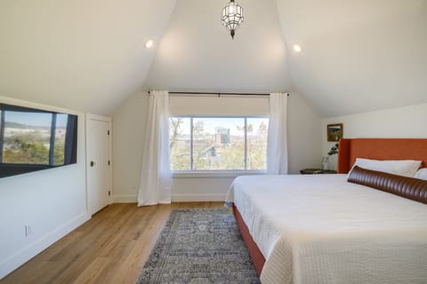 Peaceful bedroom with large window and skyline view