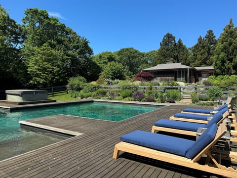 Beautiful pool and hot tub area with sun loungers