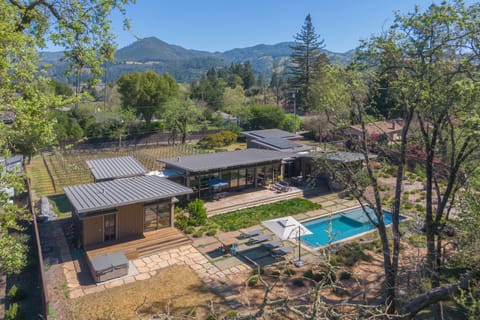 Modern luxury estate nestled in scenic mountain valley with swimming pool and expansive outdoor living spaces.