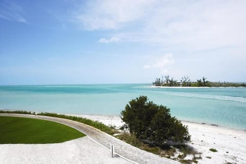 Wander along powdery sand with endless turquoise water ahead.