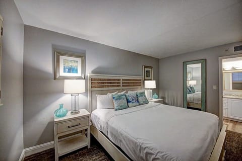 Unwind in a serene bedroom with soft lighting and coastal charm.