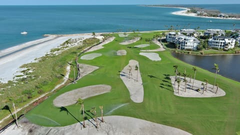 Stroll from lush fairways to pristine sand and blue water.