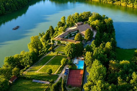 View of the property with its lake and forest
