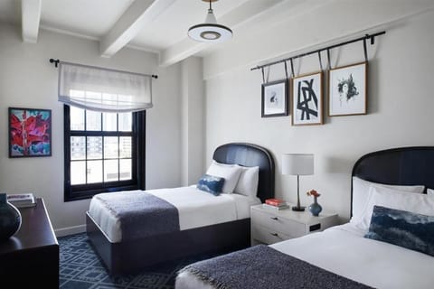 Settle in with two comfy beds and bright city light.
