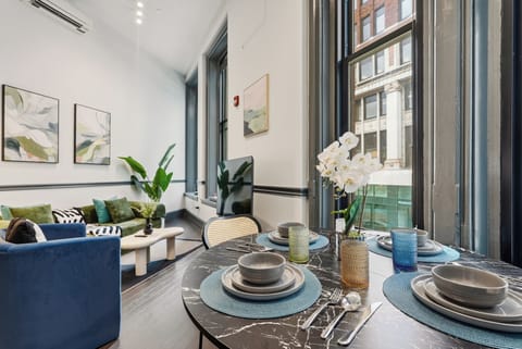 Stylish loft with soaring ceilings, large windows, and a chic dining nook