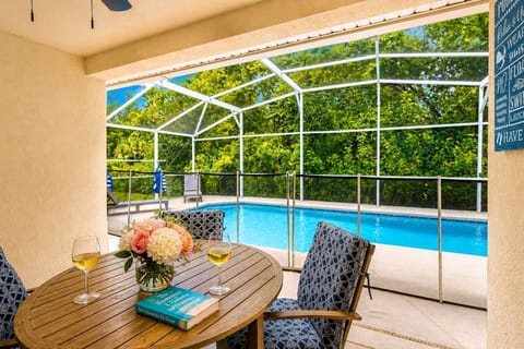 Covered patio with private pool, no rear neighbors, loungers and pool safety fence