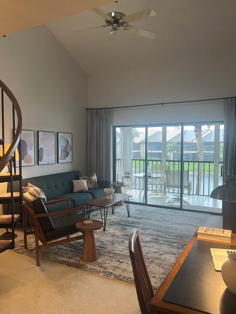 Living area with triple sliders to the lanai - lots of natural light!