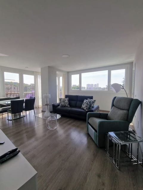 Bright corner living room with sweeping city views.

