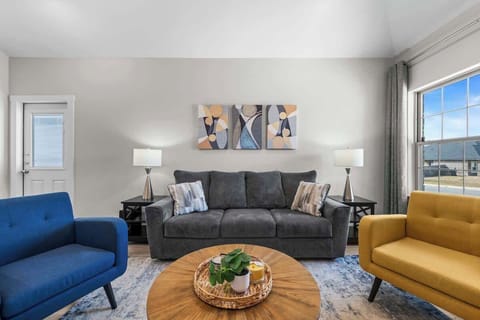 Instantly you're invited into this warm, bright vibrant living space. Relax on this comfortable sofa or sitting chairs after a long workday and enjoy watching the 4K smart TV with all your favorite apps