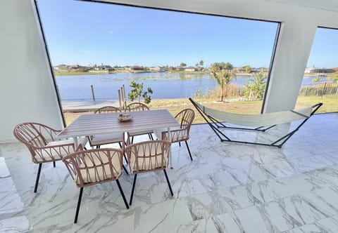 Lakeside patio with dining area and relaxing hammock views
