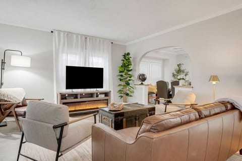 Bright, inviting living room with electric fireplace and Smart TV, perfect for relaxing after a day at the beach