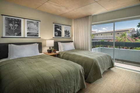 Stretch out comfortably with twin beds and sunny balcony access.