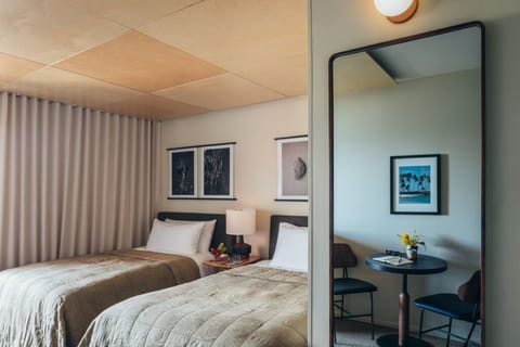 Sip morning coffee beside cozy beds in a calming retreat.