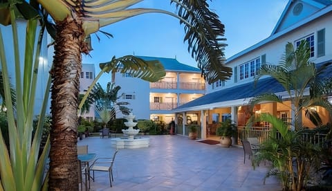 Unwind in the serene courtyard as evening lights glow softly.