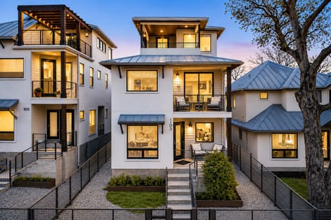 Modern three-story home with three balconies and stylish curb appeal