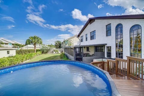 Relax in the private above-ground pool with a spacious backyard and screened patio.