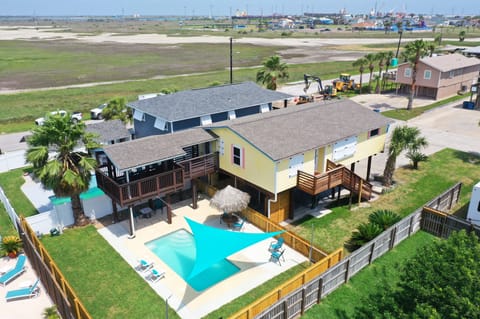Bird’s-eye view of the private pool, shaded patio, and spacious outdoor setup made for laid-back Port Aransas stays. (Tipsy Flipper)