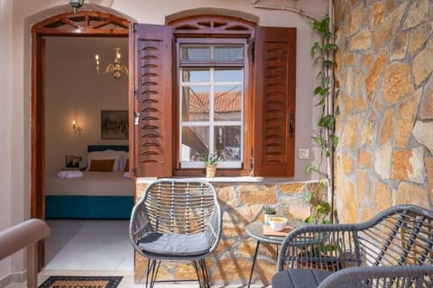 Cozy rustic patio with stone walls and warm wooden beams, creating a peaceful retreat. The outdoor seating and the calm atmosphere make it perfect for relaxing after a day of exploring nearby beaches